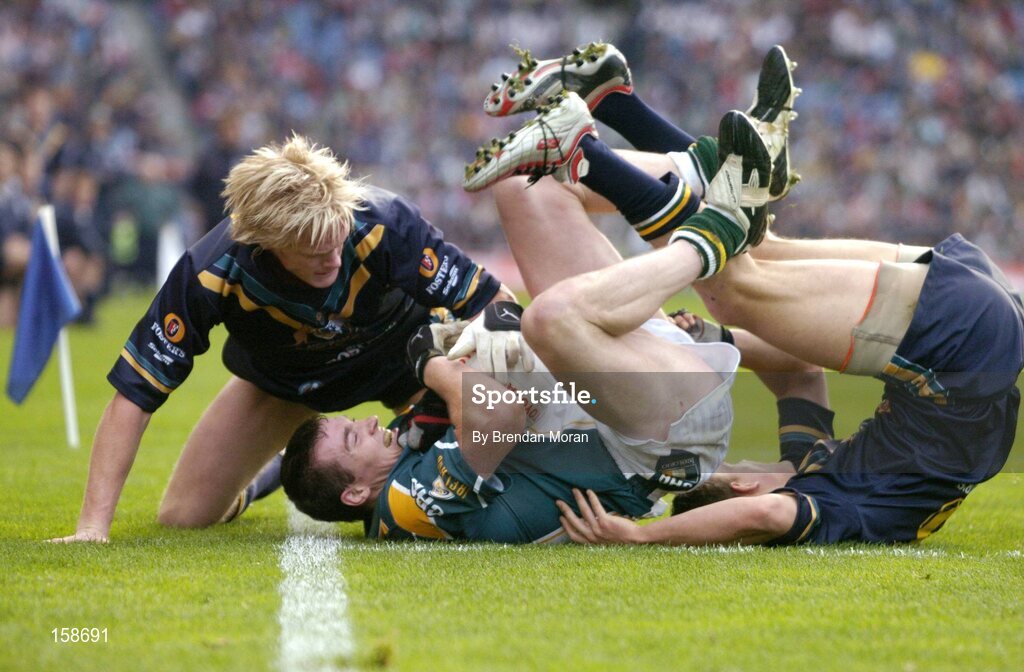17 October 2004; Ciaran McManus, Ireland, in action against Adam McPhee, left, and Luke Ball, Australia. Coca Cola International Rules Series 2004, First Test, Ireland v Australia, Croke Park, Dublin. Picture credit; Brendan Moran / SPORTSFILE *** Local Caption *** Any photograph taken by SPORTSFILE during, or in connection with, the 2004 Coca Cola International Rules Series which displays GAA logos or contains an image or part of an image of any GAA intellectual property, or, which contains images of a GAA player/players in their playing uniforms, may only be used for editorial and non-advertising purposes.  Use of photographs for advertising, as posters or for purchase separately is strictly prohibited unless prior written approval has been obtained from the Gaelic Athletic Association.