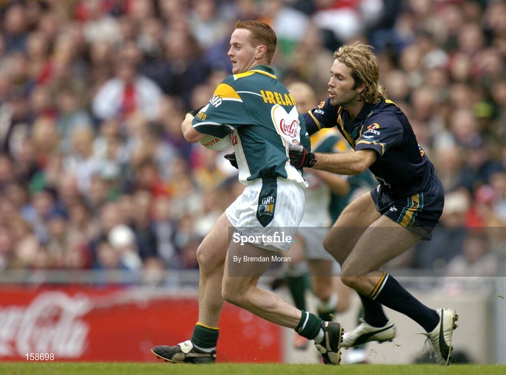 17 October 2004; Brendan Coulter, Ireland, in action against Mark McVeigh, Australia. Coca Cola International Rules Series 2004, First Test, Ireland v Australia, Croke Park, Dublin. Picture credit; Brendan Moran / SPORTSFILE *** Local Caption *** Any photograph taken by SPORTSFILE during, or in connection with, the 2004 Coca Cola International Rules Series which displays GAA logos or contains an image or part of an image of any GAA intellectual property, or, which contains images of a GAA player/players in their playing uniforms, may only be used for editorial and non-advertising purposes.  Use of photographs for advertising, as posters or for purchase separately is strictly prohibited unless prior written approval has been obtained from the Gaelic Athletic Association.