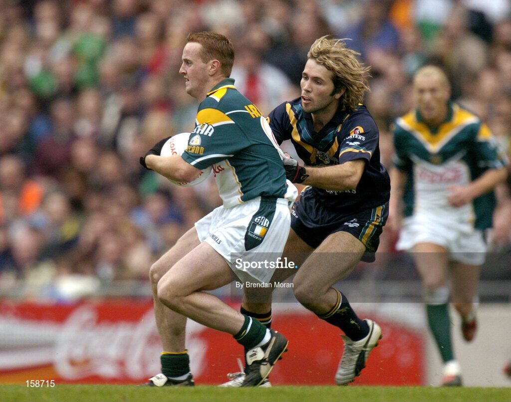 17 October 2004; Brendan Coulter, Ireland, in action against Mark McVeigh, Australia. Coca Cola International Rules Series 2004, First Test, Ireland v Australia, Croke Park, Dublin. Picture credit; Brendan Moran / SPORTSFILE *** Local Caption *** Any photograph taken by SPORTSFILE during, or in connection with, the 2004 Coca Cola International Rules Series which displays GAA logos or contains an image or part of an image of any GAA intellectual property, or, which contains images of a GAA player/players in their playing uniforms, may only be used for editorial and non-advertising purposes.  Use of photographs for advertising, as posters or for purchase separately is strictly prohibited unless prior written approval has been obtained from the Gaelic Athletic Association.