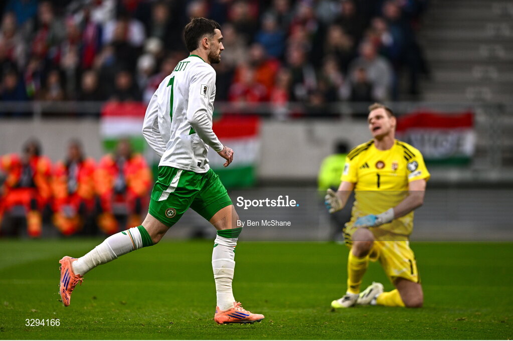 16 November 2025; Troy Parrott of Republic of Ireland after scoring his side's first goal, a penalty, past Hungary goalkeeper Dénes Dibusz during the FIFA World Cup 2026 Group F Qualifier match between Hungary and Republic of Ireland at Puskás Aréna in Budapest, Hungary. Photo by Ben McShane/Sportsfile