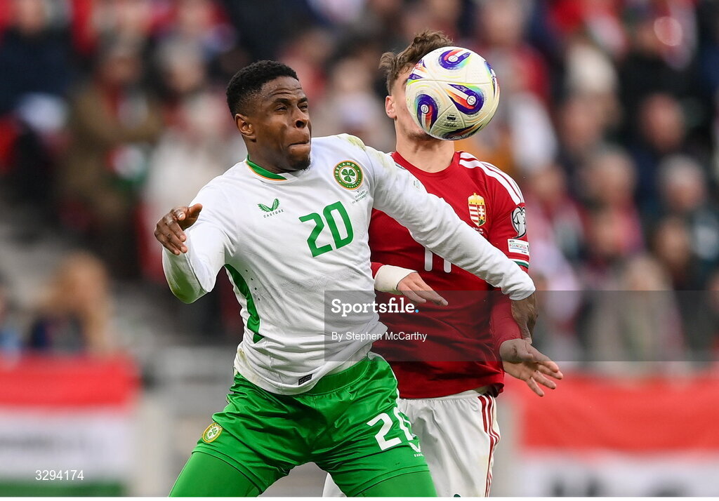 16 November 2025; Chiedozie Ogbene of Republic of Ireland in action against Milos Kerkez of Hungary during the FIFA World Cup 2026 Group F Qualifier match between Hungary and Republic of Ireland at Puskás Aréna in Budapest, Hungary. Photo by Stephen McCarthy/Sportsfile