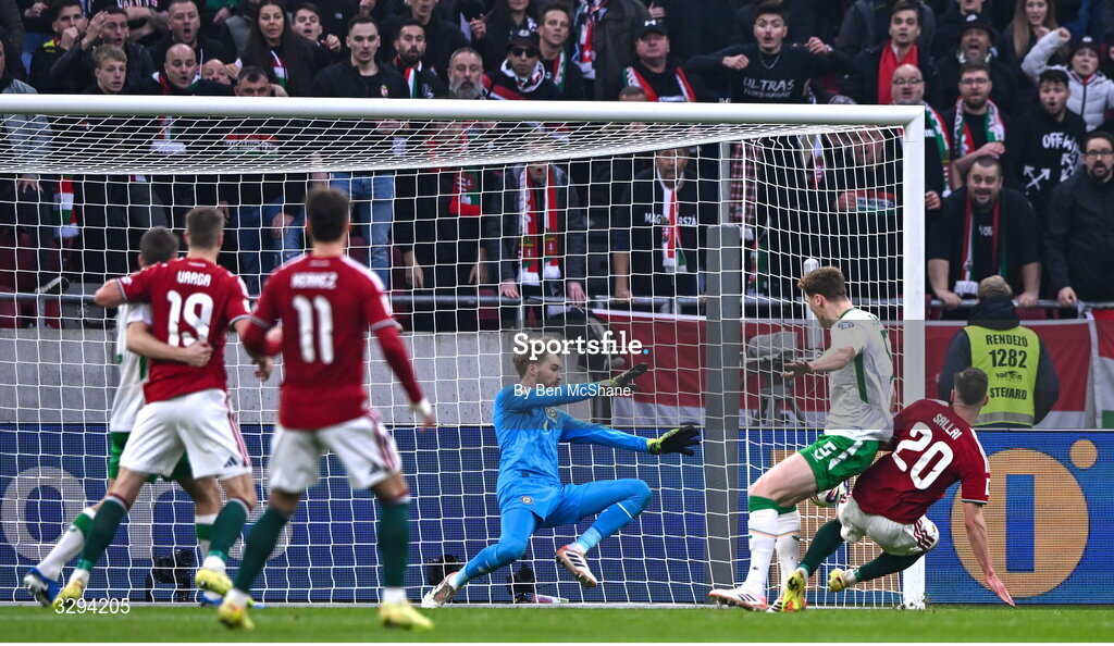 16 November 2025; Republic of Ireland goalkeeper Caoimhin Kelleher makes a save from Roland Sallai of Hungary during the FIFA World Cup 2026 Group F Qualifier match between Hungary and Republic of Ireland at Puskás Aréna in Budapest, Hungary. Photo by Ben McShane/Sportsfile