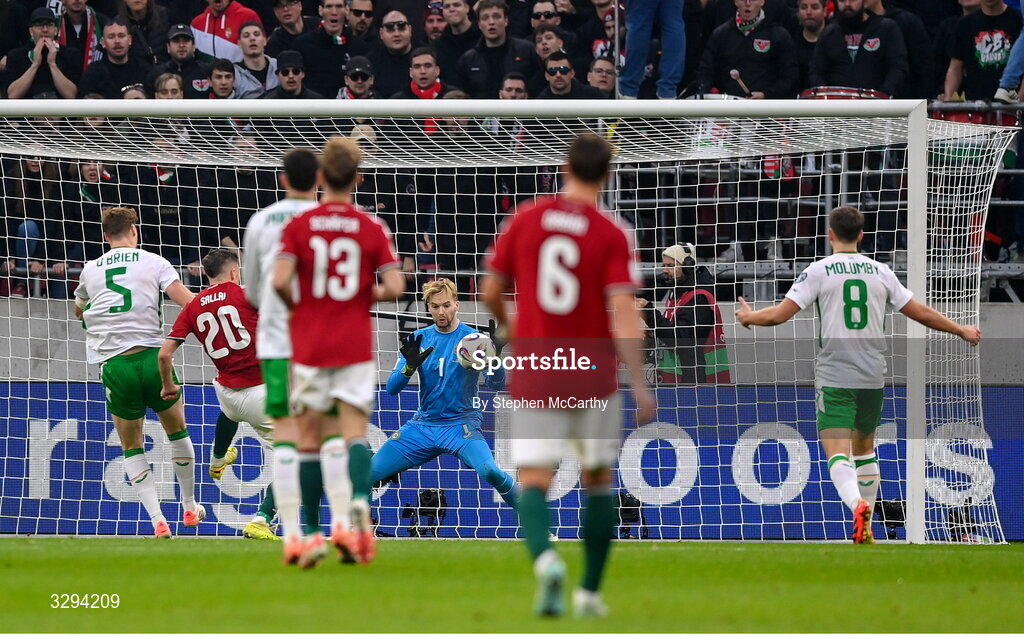 16 November 2025; Republic of Ireland goalkeeper Caoimhin Kelleher makes a save from Roland Sallai of Hungary during the FIFA World Cup 2026 Group F Qualifier match between Hungary and Republic of Ireland at Puskás Aréna in Budapest, Hungary. Photo by Stephen McCarthy/Sportsfile