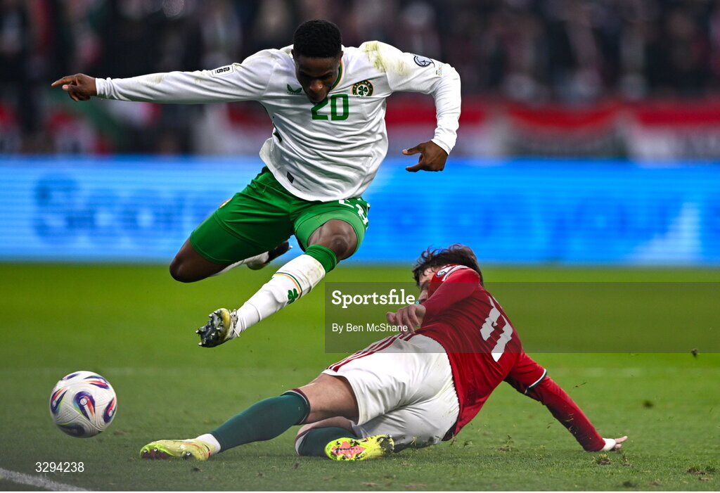 16 November 2025; Chiedozie Ogbene of Republic of Ireland is tackled by Milos Kerkez of Hungary during the FIFA World Cup 2026 Group F Qualifier match between Hungary and Republic of Ireland at Puskás Aréna in Budapest, Hungary. Photo by Ben McShane/Sportsfile