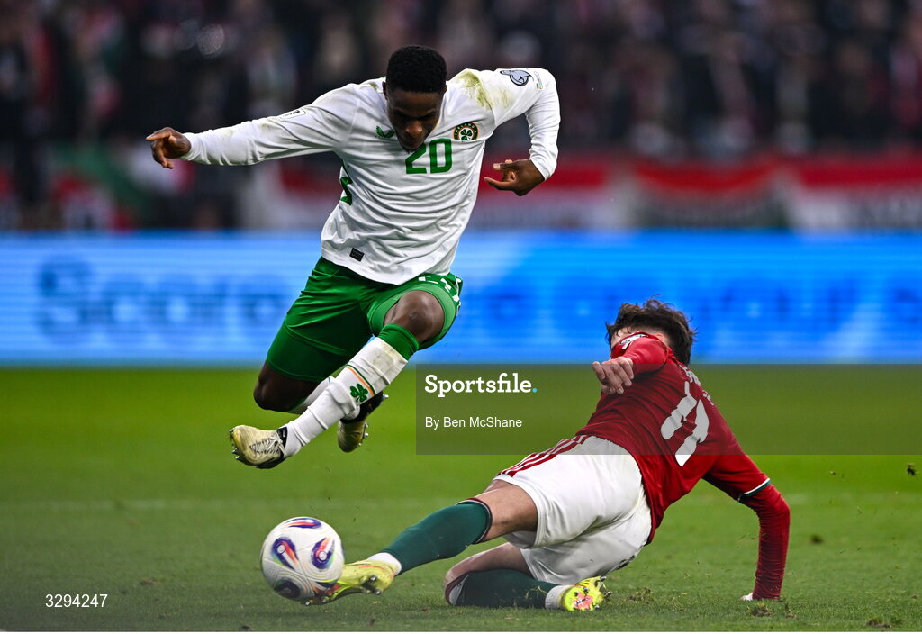 16 November 2025; Chiedozie Ogbene of Republic of Ireland is tackled by Milos Kerkez of Hungary during the FIFA World Cup 2026 Group F Qualifier match between Hungary and Republic of Ireland at Puskás Aréna in Budapest, Hungary. Photo by Ben McShane/Sportsfile