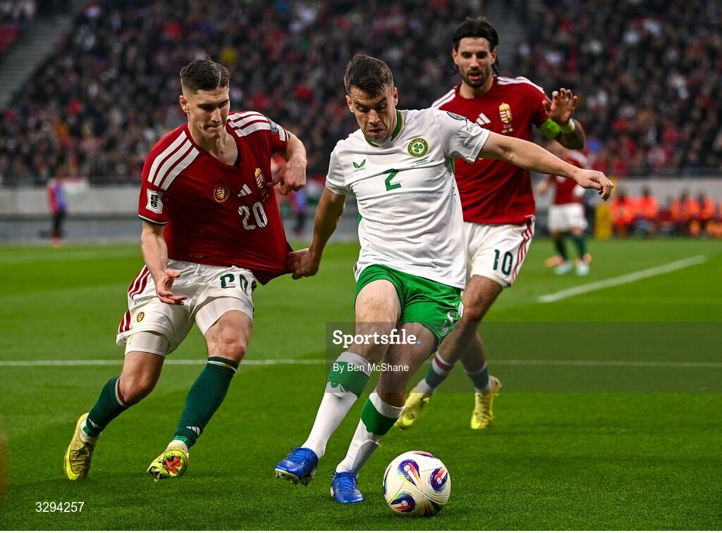 16 November 2025; Seamus Coleman of Republic of Ireland in action against Roland Sallai of Hungary during the FIFA World Cup 2026 Group F Qualifier match between Hungary and Republic of Ireland at Puskás Aréna in Budapest, Hungary. Photo by Ben McShane/Sportsfile