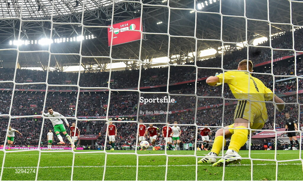 16 November 2025; Troy Parrott of Republic of Ireland scores his side's first goal, a penalty, past Hungary goalkeeper Dénes Dibusz during the FIFA World Cup 2026 Group F Qualifier match between Hungary and Republic of Ireland at Puskás Aréna in Budapest, Hungary. Photo by Ben McShane/Sportsfile