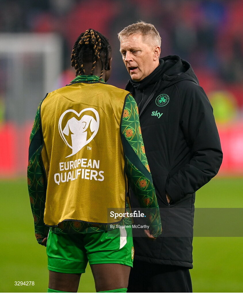 16 November 2025; Republic of Ireland head coach Heimir Hallgrimsson in conversation with Festy Ebosele of Republic of Ireland at half-time of the FIFA World Cup 2026 Group F Qualifier match between Hungary and Republic of Ireland at Puskás Aréna in Budapest, Hungary. Photo by Stephen McCarthy/Sportsfile
