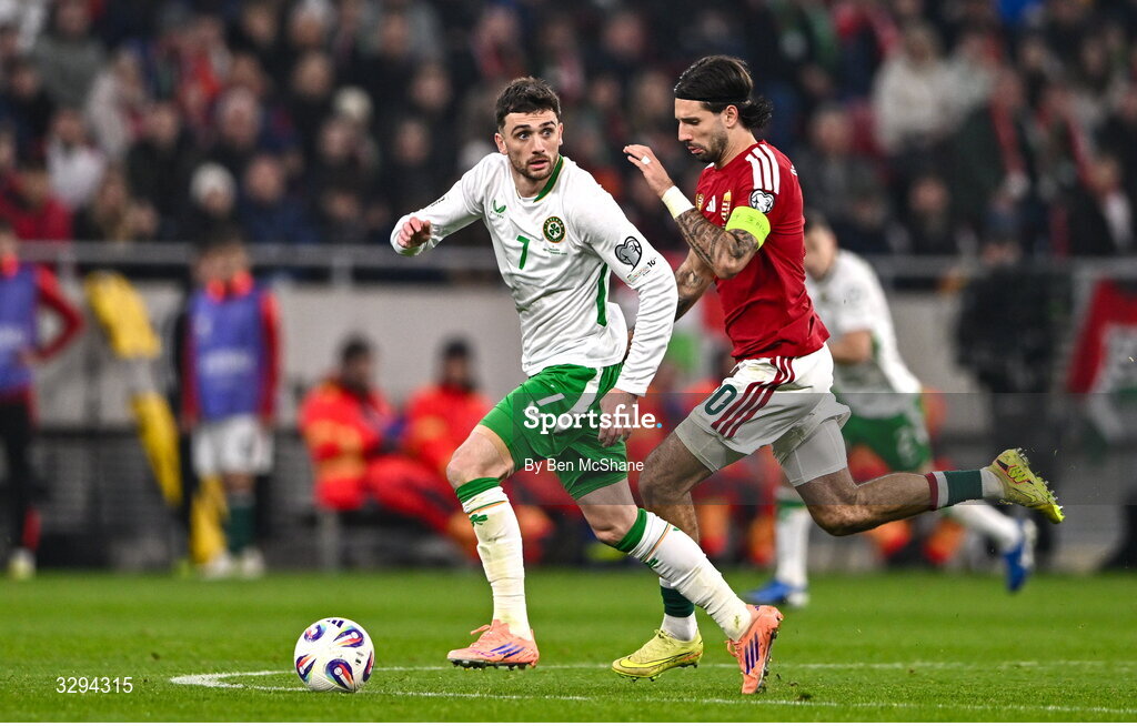 16 November 2025; Troy Parrott of Republic of Ireland in action against Dominik Szoboszlai of Hungary during the FIFA World Cup 2026 Group F Qualifier match between Hungary and Republic of Ireland at Puskás Aréna in Budapest, Hungary. Photo by Ben McShane/Sportsfile