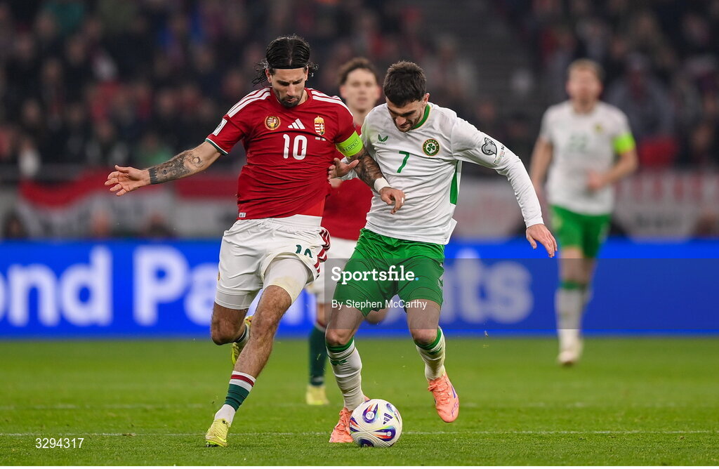 16 November 2025; Troy Parrott of Republic of Ireland in action against Dominik Szoboszlai of Hungary during the FIFA World Cup 2026 Group F Qualifier match between Hungary and Republic of Ireland at Puskás Aréna in Budapest, Hungary. Photo by Stephen McCarthy/Sportsfile