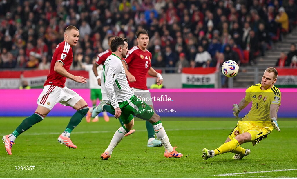 16 November 2025; Troy Parrott of Republic of Ireland scores his side's second goal past Hungary goalkeeper Dénes Dibusz during the FIFA World Cup 2026 Group F Qualifier match between Hungary and Republic of Ireland at Puskás Aréna in Budapest, Hungary. Photo by Stephen McCarthy/Sportsfile