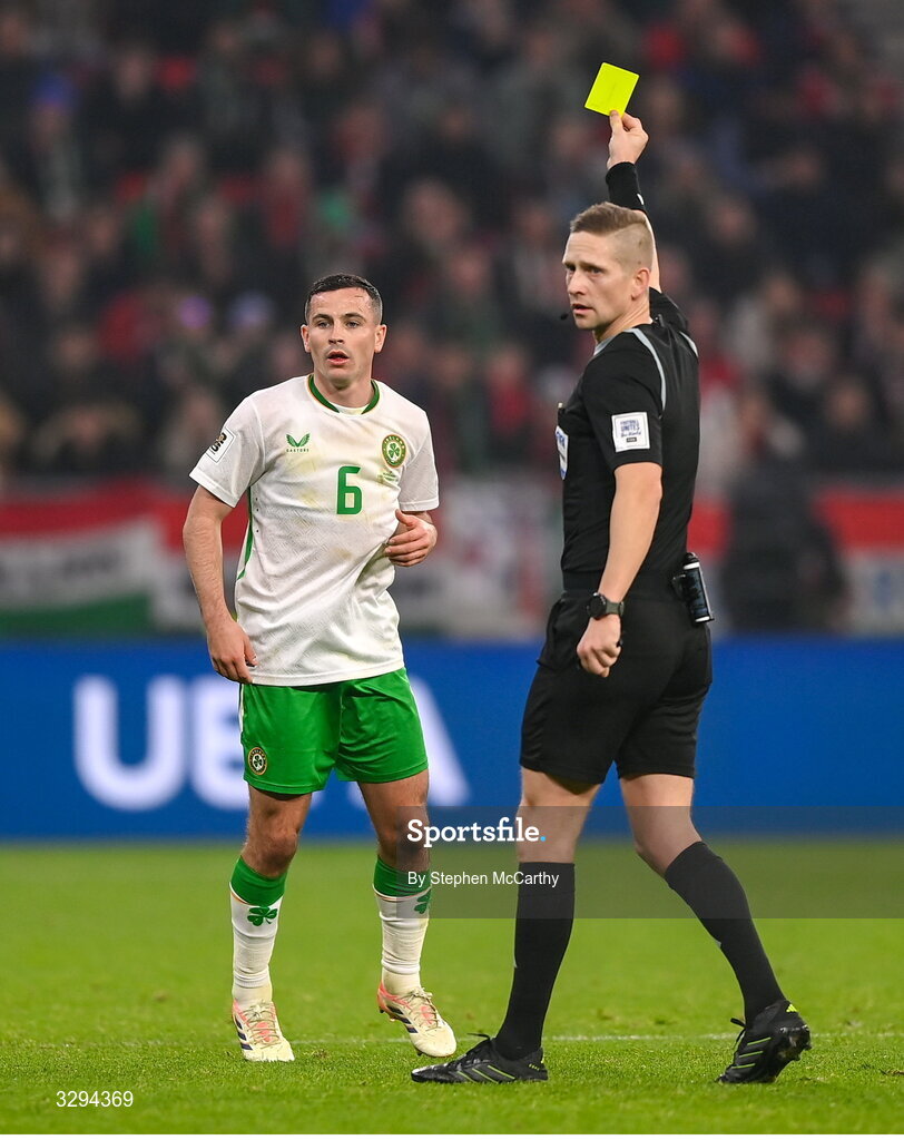 16 November 2025; Josh Cullen of Republic of Ireland is shown a yellow card by referee Espen Eskas during the FIFA World Cup 2026 Group F Qualifier match between Hungary and Republic of Ireland at Puskás Aréna in Budapest, Hungary. Photo by Stephen McCarthy/Sportsfile
