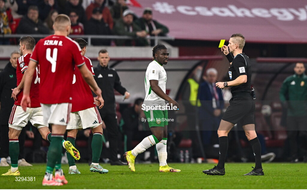 16 November 2025; Festy Ebosele of Republic of Ireland is shown a yellow card by referee Espen Eskas during the FIFA World Cup 2026 Group F Qualifier match between Hungary and Republic of Ireland at Puskás Aréna in Budapest, Hungary. Photo by Ben McShane/Sportsfile