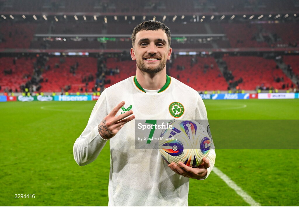 16 November 2025; Troy Parrott of Republic of Ireland celebrates with the match ball, after scoring a hat-trick, after the FIFA World Cup 2026 Group F Qualifier match between Hungary and Republic of Ireland at Puskás Aréna in Budapest, Hungary. Photo by Stephen McCarthy/Sportsfile