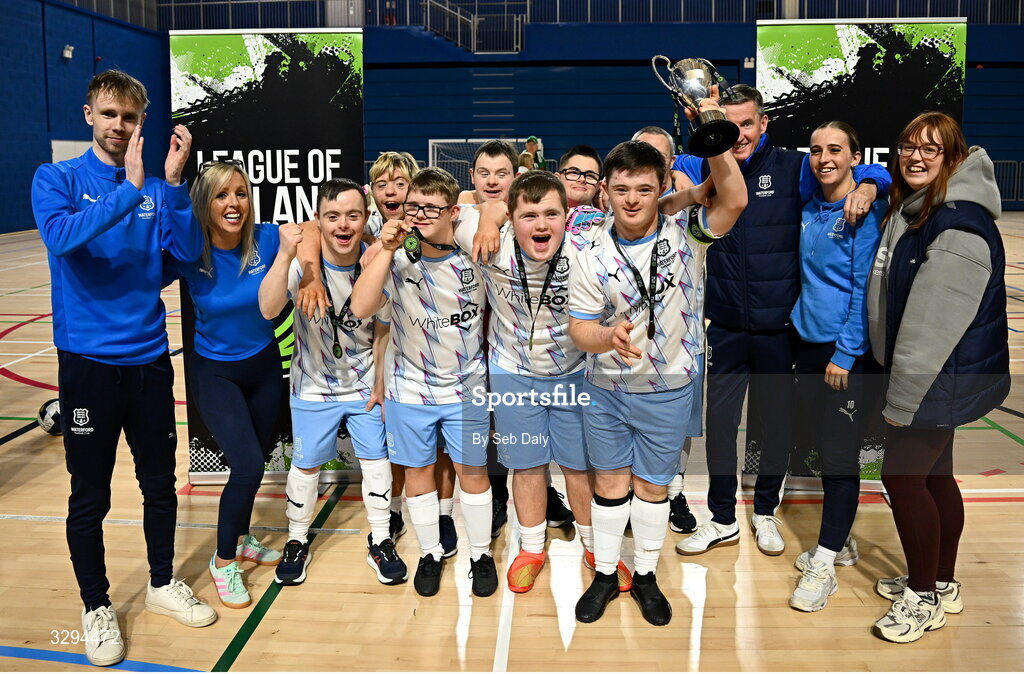 16 November 2025; Waterford captain Sean Toolin lifts the championship cup alongside teammates and coaches after their side's victory at LOI Cairdeas Cup Festival at the National Indoor Arena on the Sport Ireland Campus in Dublin. Photo by Seb Daly/Sportsfile