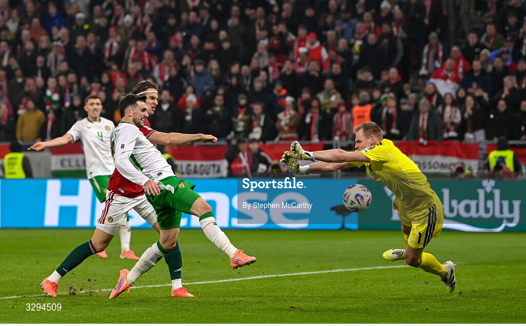 16 November 2025; Troy Parrott of Republic of Ireland scores his side's third goal past Hungary goalkeeper Dénes Dibusz during the FIFA World Cup 2026 Group F Qualifier match between Hungary and Republic of Ireland at Puskás Aréna in Budapest, Hungary. Photo by Stephen McCarthy/Sportsfile