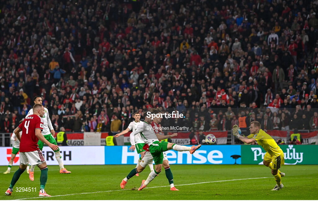 16 November 2025; Troy Parrott of Republic of Ireland scores his side's third goal past Hungary goalkeeper Dénes Dibusz during the FIFA World Cup 2026 Group F Qualifier match between Hungary and Republic of Ireland at Puskás Aréna in Budapest, Hungary. Photo by Stephen McCarthy/Sportsfile