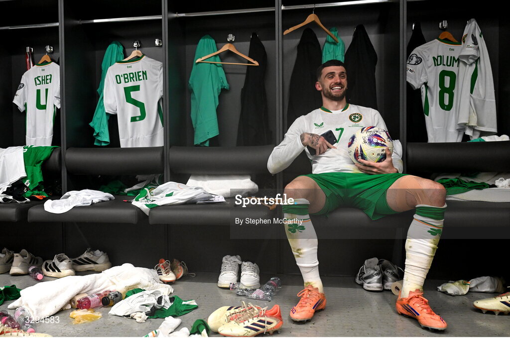 16 November 2025; Troy Parrott of Republic of Ireland celebrates with the match ball in the dressing room after scoring a hat-trick in the FIFA World Cup 2026 Group F Qualifier match between Hungary and Republic of Ireland at Puskás Aréna in Budapest, Hungary. Photo by Stephen McCarthy/Sportsfile