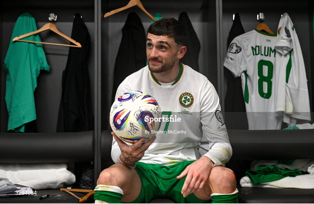 16 November 2025; Troy Parrott of Republic of Ireland celebrates with the match ball in the dressing room after scoring a hat-trick in the FIFA World Cup 2026 Group F Qualifier match between Hungary and Republic of Ireland at Puskás Aréna in Budapest, Hungary. Photo by Stephen McCarthy/Sportsfile