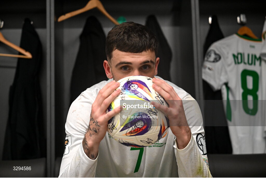 16 November 2025; Troy Parrott of Republic of Ireland celebrates with the match ball in the dressing room after scoring a hat-trick in the FIFA World Cup 2026 Group F Qualifier match between Hungary and Republic of Ireland at Puskás Aréna in Budapest, Hungary. Photo by Stephen McCarthy/Sportsfile