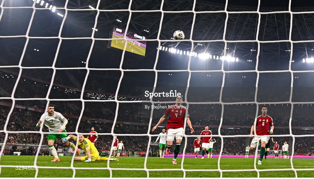 16 November 2025; Troy Parrott of Republic of Ireland scores his side's second goal past Hungary goalkeeper Dénes Dibusz during the FIFA World Cup 2026 Group F Qualifier match between Hungary and Republic of Ireland at Puskás Aréna in Budapest, Hungary. Photo by Stephen McCarthy/Sportsfile