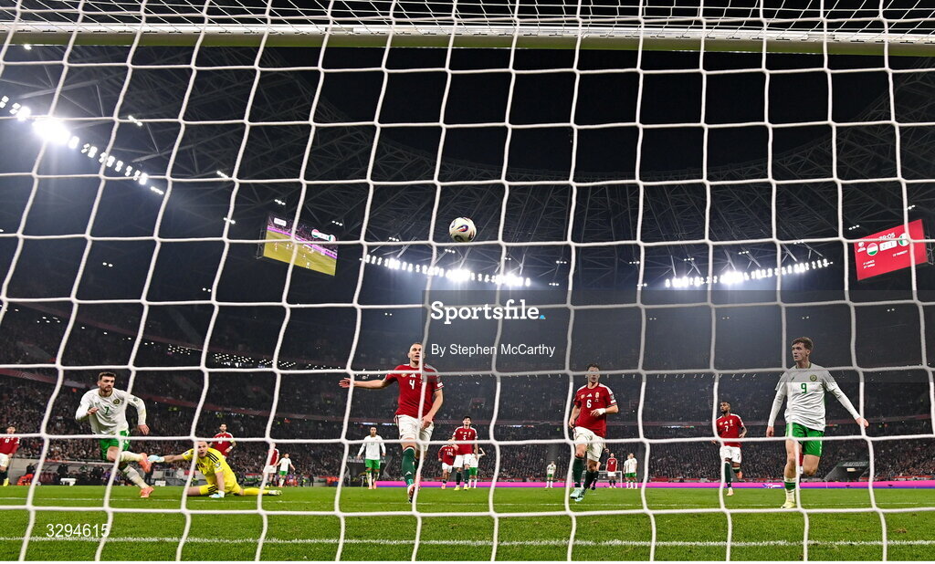 16 November 2025; Troy Parrott of Republic of Ireland scores his side's second goal past Hungary goalkeeper Dénes Dibusz during the FIFA World Cup 2026 Group F Qualifier match between Hungary and Republic of Ireland at Puskás Aréna in Budapest, Hungary. Photo by Stephen McCarthy/Sportsfile