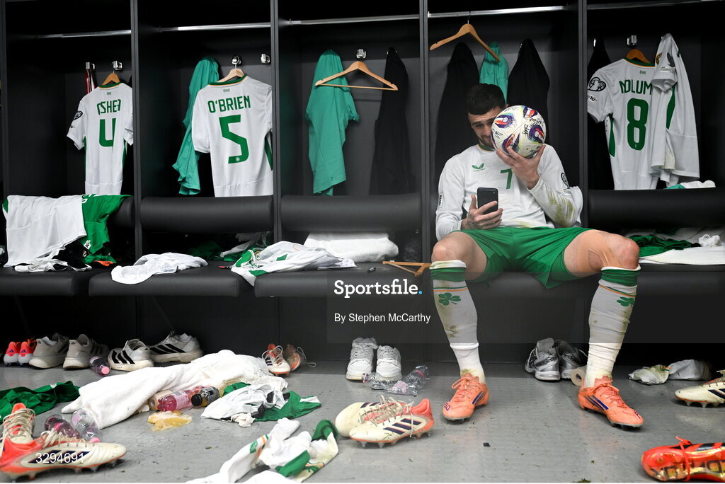 16 November 2025; Troy Parrott of Republic of Ireland celebrates with the match ball in the dressing room after scoring a hat-trick in the FIFA World Cup 2026 Group F Qualifier match between Hungary and Republic of Ireland at Puskás Aréna in Budapest, Hungary. Photo by Stephen McCarthy/Sportsfile