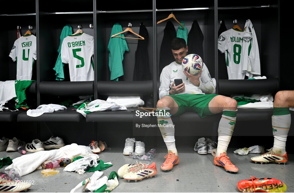 16 November 2025; Troy Parrott of Republic of Ireland celebrates with the match ball in the dressing room after scoring a hat-trick in the FIFA World Cup 2026 Group F Qualifier match between Hungary and Republic of Ireland at Puskás Aréna in Budapest, Hungary. Photo by Stephen McCarthy/Sportsfile