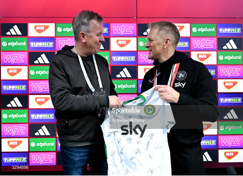 16 November 2025; Republic of Ireland head coach Heimir Hallgrimsson presents a signed Republic of Ireland jersey to retiring RTÉ sport journalist Ed Leahy after the FIFA World Cup 2026 Group F Qualifier match between Hungary and Republic of Ireland at Puskás Aréna in Budapest, Hungary. Photo by Stephen McCarthy/Sportsfile