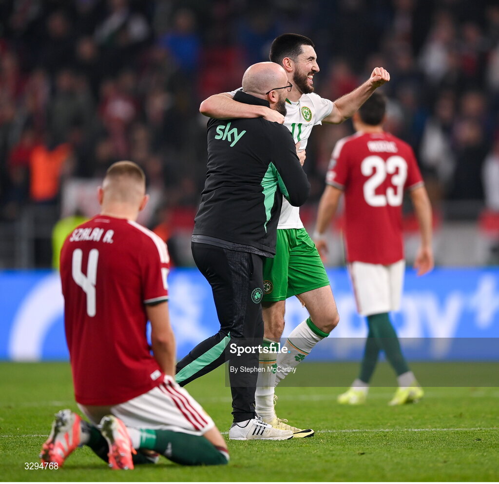 16 November 2025; Republic of Ireland's Finn Azaz celebrates with kit and equipment manager Karl McKenna after the FIFA World Cup 2026 Group F Qualifier match between Hungary and Republic of Ireland at Puskás Aréna in Budapest, Hungary. Photo by Stephen McCarthy/Sportsfile