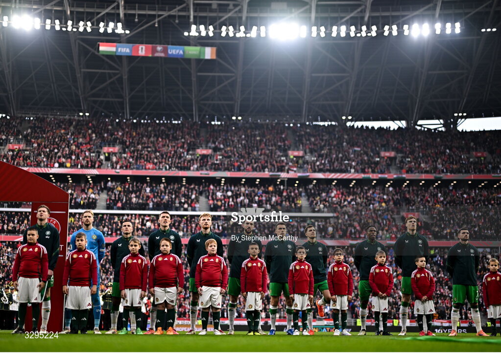 16 November 2025; Republic of Ireland players, from left, Nathan Collins, goalkeeper Caoimhin Kelleher, Josh Cullen, Dara O'Shea, Liam Scales, Finn Azaz, Seamus Coleman, Jayson Molumby, Chiedozie Ogbene, Jake O'Brien and Troy Parrott stand for the playing of the National Anthem before the FIFA World Cup 2026 Group F Qualifier match between Hungary and Republic of Ireland at Puskás Aréna in Budapest, Hungary. Photo by Stephen McCarthy/Sportsfile