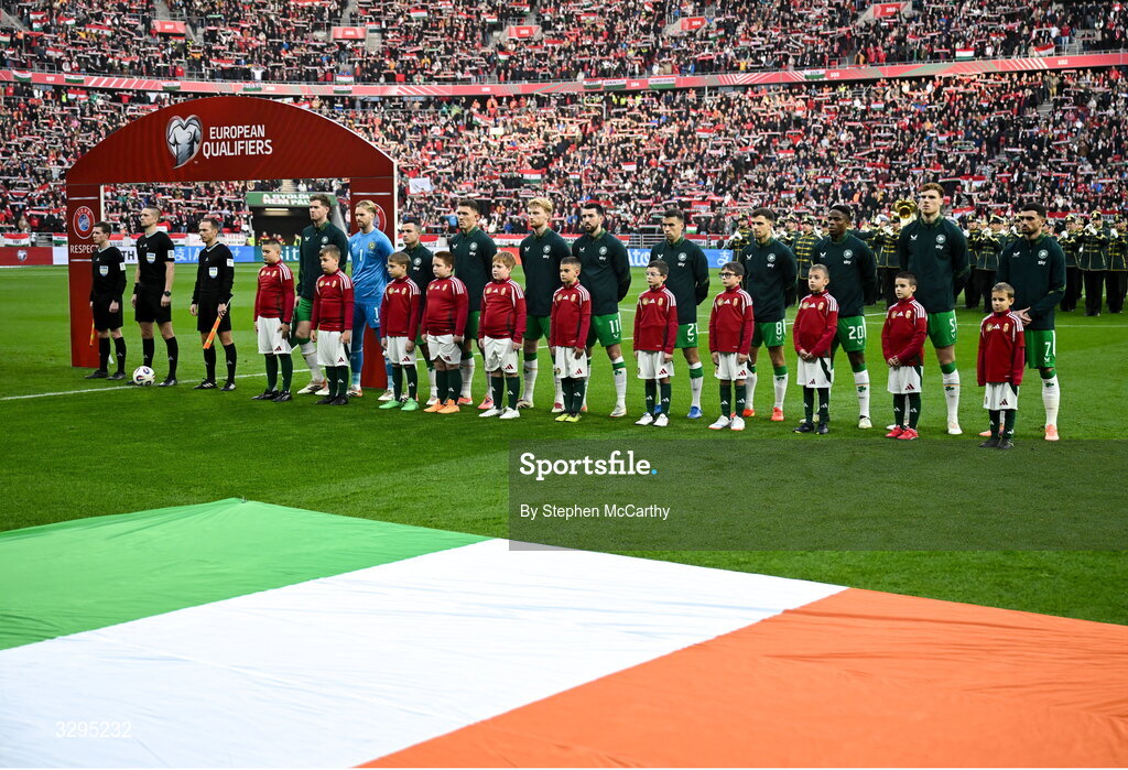 16 November 2025; Republic of Ireland players, from left, Nathan Collins, goalkeeper Caoimhin Kelleher, Josh Cullen, Dara O'Shea, Liam Scales, Finn Azaz, Seamus Coleman, Jayson Molumby, Chiedozie Ogbene, Jake O'Brien and Troy Parrott stand for the playing of the National Anthems before the FIFA World Cup 2026 Group F Qualifier match between Hungary and Republic of Ireland at Puskás Aréna in Budapest, Hungary. Photo by Stephen McCarthy/Sportsfile