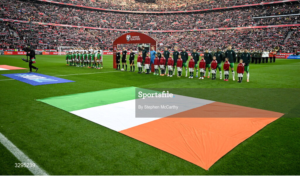 16 November 2025; Republic of Ireland players, from left, Nathan Collins, goalkeeper Caoimhin Kelleher, Josh Cullen, Dara O'Shea, Liam Scales, Finn Azaz, Seamus Coleman, Jayson Molumby, Chiedozie Ogbene, Jake O'Brien and Troy Parrott stand for the playing of the National Anthems before the FIFA World Cup 2026 Group F Qualifier match between Hungary and Republic of Ireland at Puskás Aréna in Budapest, Hungary. Photo by Stephen McCarthy/Sportsfile