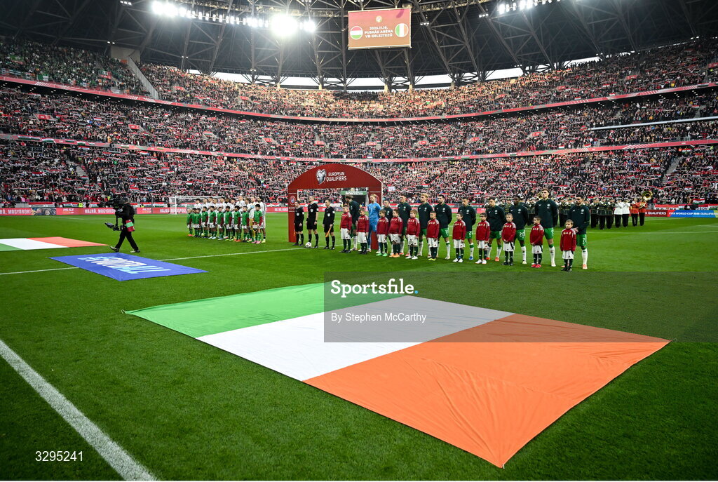 16 November 2025; Republic of Ireland players, from left, Nathan Collins, goalkeeper Caoimhin Kelleher, Josh Cullen, Dara O'Shea, Liam Scales, Finn Azaz, Seamus Coleman, Jayson Molumby, Chiedozie Ogbene, Jake O'Brien and Troy Parrott stand for the playing of the National Anthems before the FIFA World Cup 2026 Group F Qualifier match between Hungary and Republic of Ireland at Puskás Aréna in Budapest, Hungary. Photo by Stephen McCarthy/Sportsfile