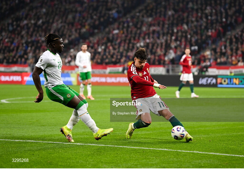 16 November 2025; Milos Kerkez of Hungary in action against Festy Ebosele of Republic of Ireland during the FIFA World Cup 2026 Group F Qualifier match between Hungary and Republic of Ireland at Puskás Aréna in Budapest, Hungary. Photo by Stephen McCarthy/Sportsfile