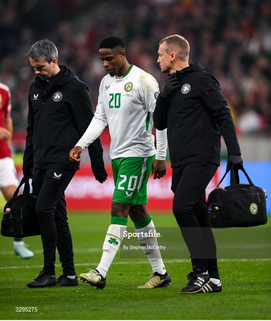 16 November 2025; Chiedozie Ogbene of Republic of Ireland leaves the pitch with team doctor Sean Carmody, left, and lead physiotherapist Danny Miller, right, after picking up an injury during the FIFA World Cup 2026 Group F Qualifier match between Hungary and Republic of Ireland at Puskás Aréna in Budapest, Hungary. Photo by Stephen McCarthy/Sportsfile