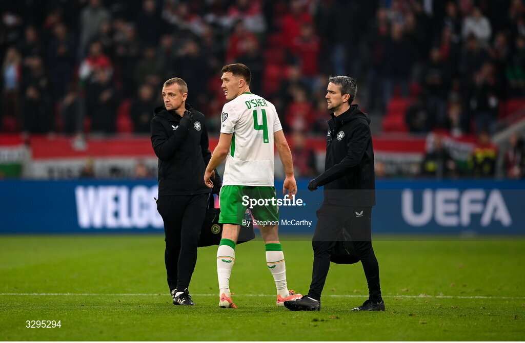 16 November 2025; Dara O'Shea of Republic of Ireland with lead physiotherapist Danny Miller, left, and team doctor Sean Carmody, right, during the FIFA World Cup 2026 Group F Qualifier match between Hungary and Republic of Ireland at Puskás Aréna in Budapest, Hungary. Photo by Stephen McCarthy/Sportsfile