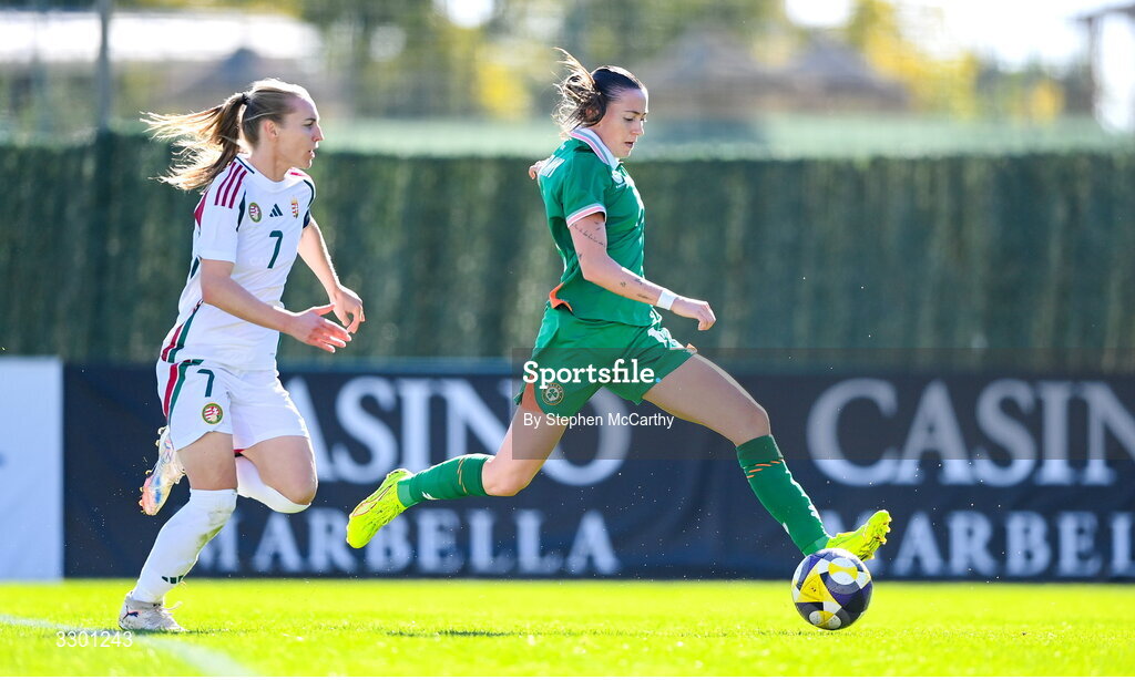 29 November 2025; Abbie Larkin of Republic of Ireland on her way to scoring her side's first goal despite the attention of Henrietta Csiszar of Hungary during the women's international friendly match between Republic of Ireland and Hungary at Marbella Football Centre in Marbella, Spain. Photo by Stephen McCarthy/Sportsfile