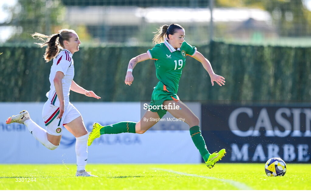 29 November 2025; Abbie Larkin of Republic of Ireland on her way to scoring her side's first goal despite the attention of Henrietta Csiszar of Hungary during the women's international friendly match between Republic of Ireland and Hungary at Marbella Football Centre in Marbella, Spain. Photo by Stephen McCarthy/Sportsfile