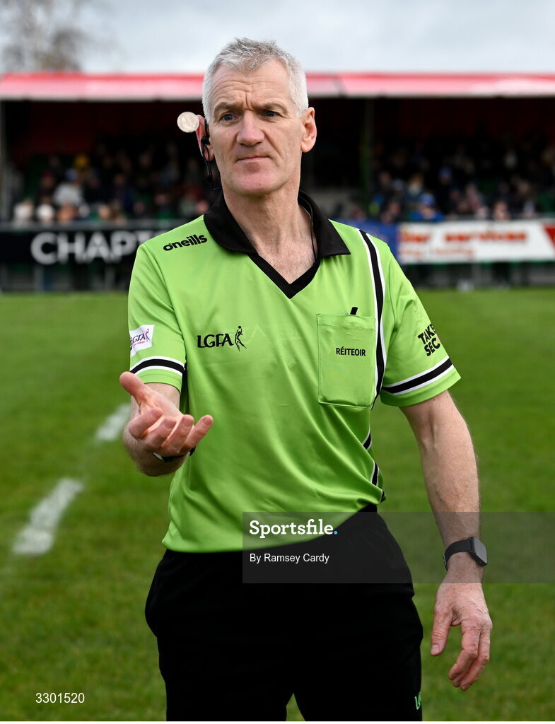 29 November 2025; Referee Philip Conway performs the coin toss before the AIB All-Ireland Ladies Football Club Junior Club Championship semi-final match between Cavan Gaels of Cavan and Cromane of Kerry at Terry Coyle Park in Cavan. Photo by Ramsey Cardy/Sportsfile