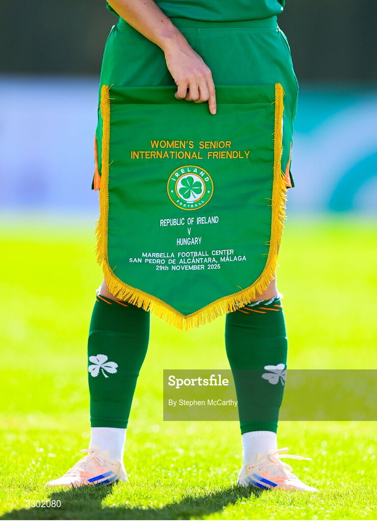 29 November 2025; A general view of the Republic of Ireland match pennant being held by Republic of Ireland captain Katie McCabe before the women's international friendly match between Republic of Ireland and Hungary at Marbella Football Centre in Marbella, Spain. Photo by Stephen McCarthy/Sportsfile