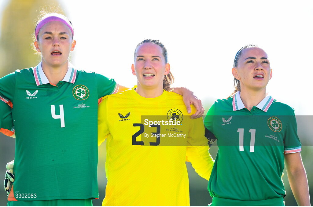 29 November 2025; Republic of Ireland players, from left, Caitlin Hayes, goalkeeper Sophie Whitehouse and Katie McCabe stand for the playing of the National Anthem before the women's international friendly match between Republic of Ireland and Hungary at Marbella Football Centre in Marbella, Spain. Photo by Stephen McCarthy/Sportsfile