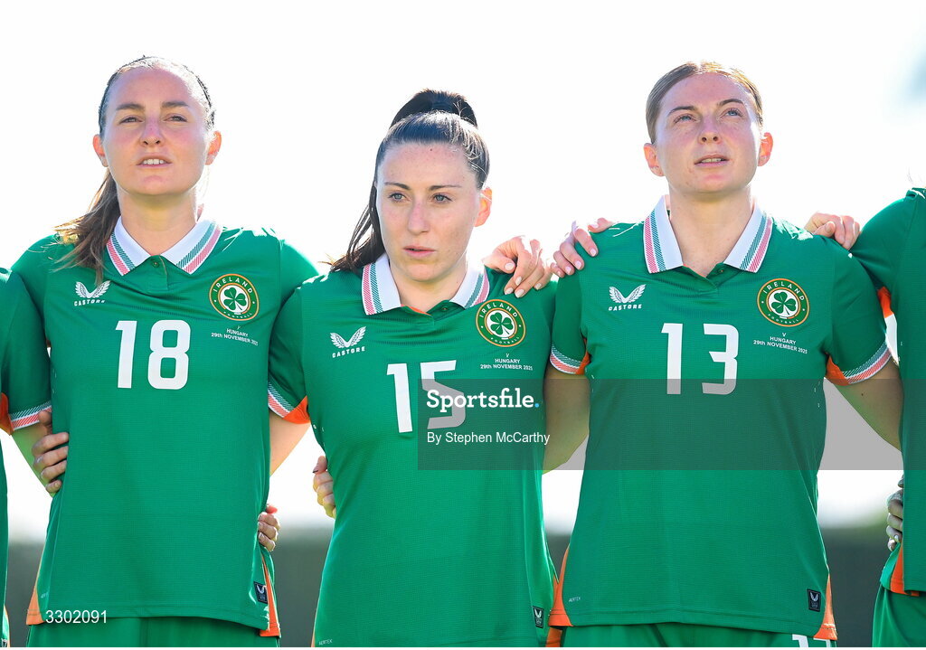 29 November 2025; Republic of Ireland players, from left, Kyra Carusa, Lucy Quinn and Hayley Nolan stand for the playing of the National Anthem before the women's international friendly match between Republic of Ireland and Hungary at Marbella Football Centre in Marbella, Spain. Photo by Stephen McCarthy/Sportsfile