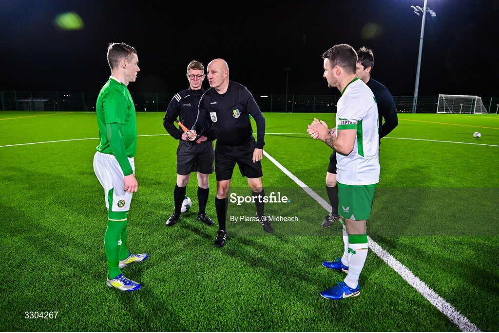 3 December 2025; Referee Paul Tuite with team captains Jimmy Carr of Ireland Amateur, left, and Aidan Friel of Irish Defence Forces for the coin toss before the representative friendly match between Ireland Amateur and Irish Defence Forces at Wayside Celtic FC in Dublin. Photo by Piaras Ó Mídheach/Sportsfile
