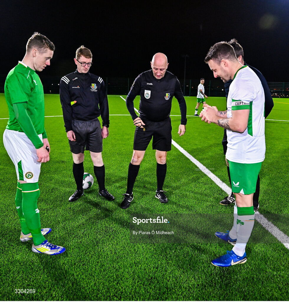 3 December 2025; Referee Paul Tuite with team captains Jimmy Carr of Ireland Amateur, left, and Aidan Friel of Irish Defence Forces for the coin toss before the representative friendly match between Ireland Amateur and Irish Defence Forces at Wayside Celtic FC in Dublin. Photo by Piaras Ó Mídheach/Sportsfile