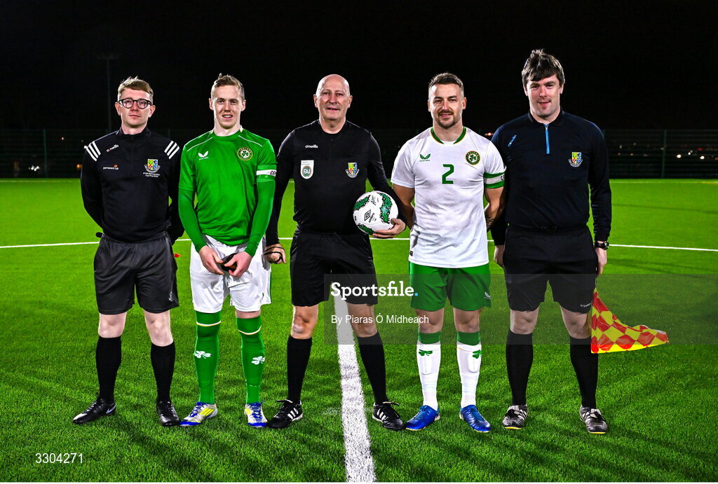 3 December 2025; Referee Paul Tuite with his match officials and team captains Jimmy Carr of Ireland Amateur and Aidan Friel of Irish Defence Forces, 2, before the representative friendly match between Ireland Amateur and Irish Defence Forces at Wayside Celtic FC in Dublin. Photo by Piaras Ó Mídheach/Sportsfile