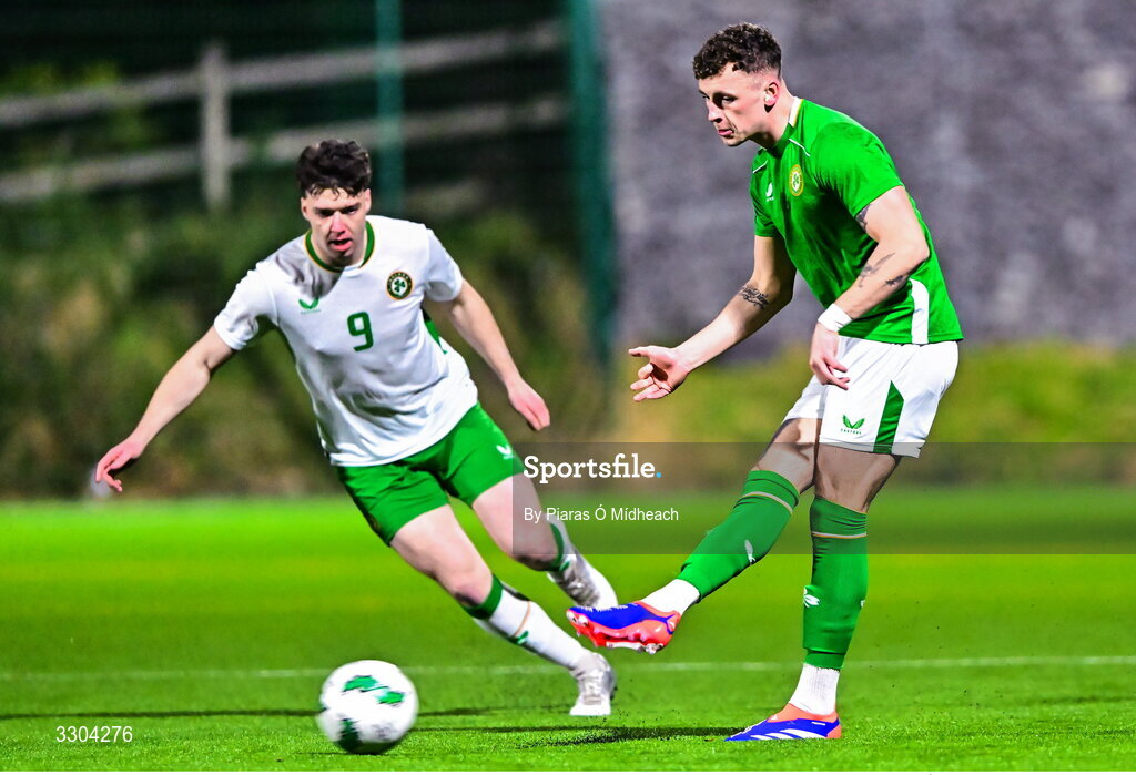 3 December 2025; Jake Dillon of Ireland Amateur in action against Ronan Kierns of Irish Defence Forces, left, during the representative friendly match between Ireland Amateur and Irish Defence Forces at Wayside Celtic FC in Dublin. Photo by Piaras Ó Mídheach/Sportsfile