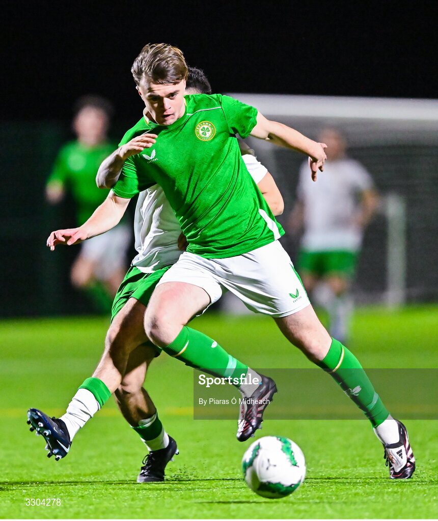 3 December 2025; Harvey Cullinan of Ireland Amateur in action against Callum Lynch of Irish Defence Forces, behind, during the representative friendly match between Ireland Amateur and Irish Defence Forces at Wayside Celtic FC in Dublin. Photo by Piaras Ó Mídheach/Sportsfile