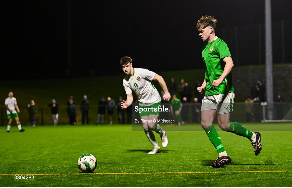 3 December 2025; Harvey Cullinan of Ireland Amateur in action against Ronan Kierns of Irish Defence Forces, 9, during the representative friendly match between Ireland Amateur and Irish Defence Forces at Wayside Celtic FC in Dublin. Photo by Piaras Ó Mídheach/Sportsfile