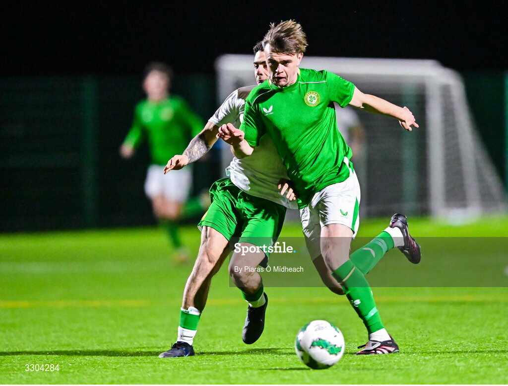 3 December 2025; Harvey Cullinan of Ireland Amateur in action against Callum Lynch of Irish Defence Forces, behind, during the representative friendly match between Ireland Amateur and Irish Defence Forces at Wayside Celtic FC in Dublin. Photo by Piaras Ó Mídheach/Sportsfile
